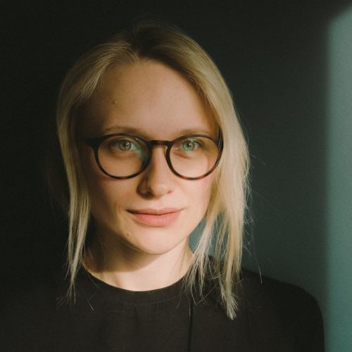 woman in black crew neck shirt wearing eyeglasses
