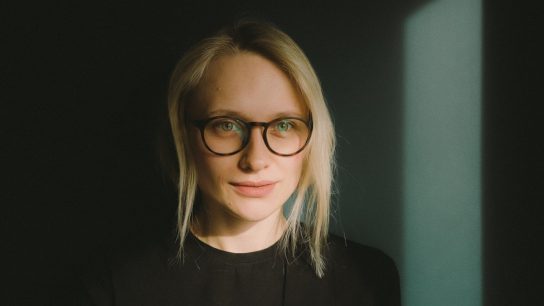 woman in black crew neck shirt wearing eyeglasses