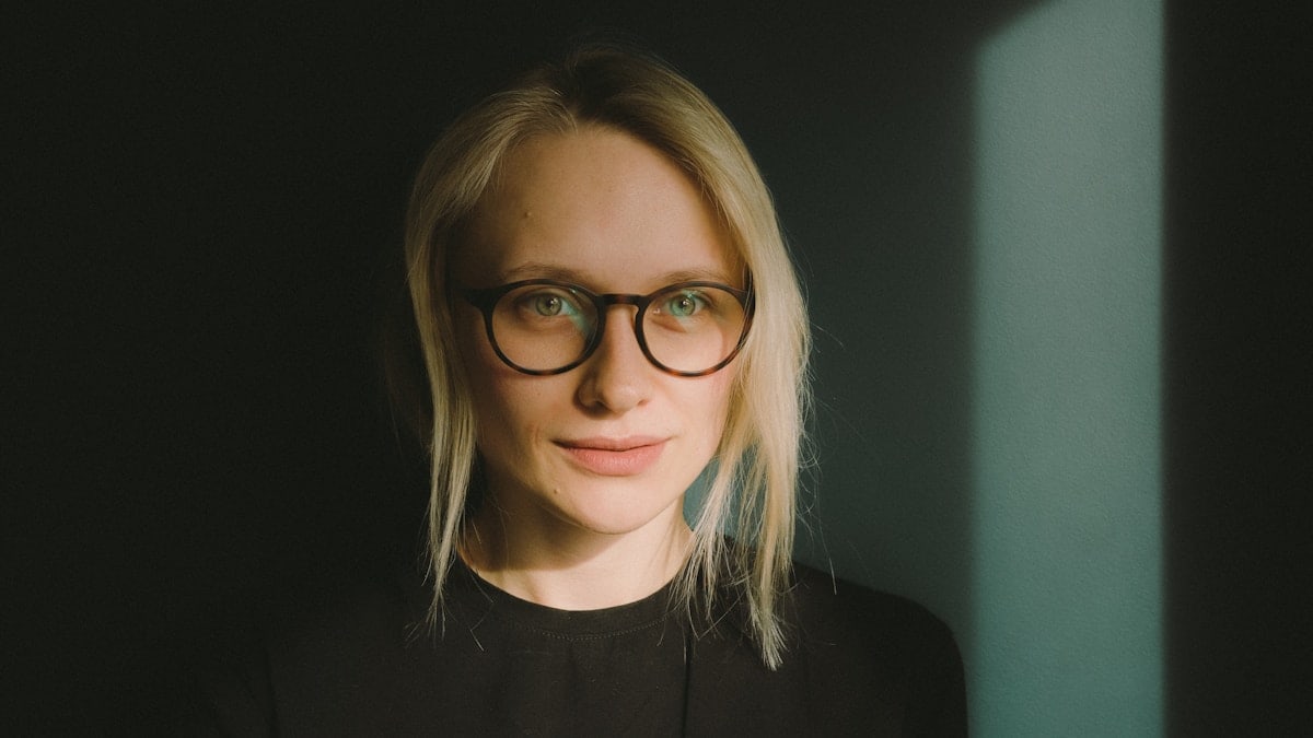 woman in black crew neck shirt wearing eyeglasses